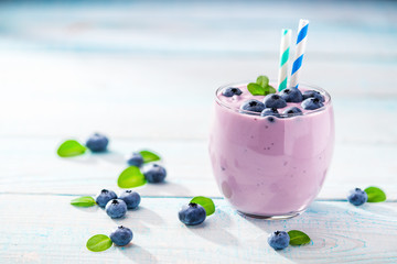 Bowl of blueberry   smoothie on wooden background