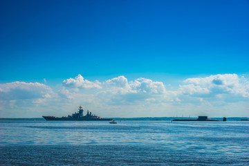 A military cruiser and a submarine. Warships.