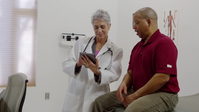 Patient talking to doctor and using a tablet