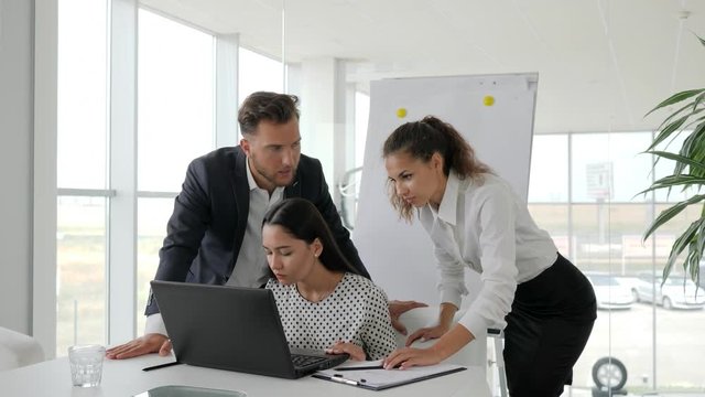joyful embrace of collaborators at office space, Successful business deal on Internet on laptop, Happy Business partners at work, Brainstorming office workers With computer in table,