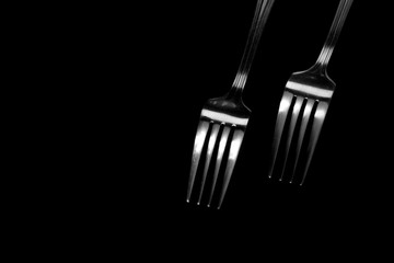 Fork background / A fork is a tool consisting of a handle with several narrow tines on one end