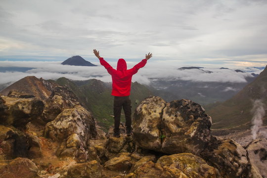 Freedom man standing on top of Mount Sibayak, Indonesia