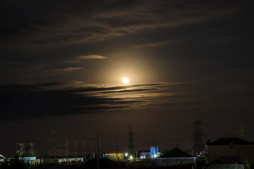 Fototapeta premium Moon, clouds over the village