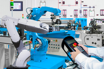 Engineer control automatic robotic hand machine tool at industrial manufacture