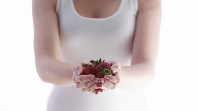 Woman holding strawberries