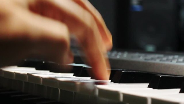 Music band concept background.Close up the man playing electric piano.Mix variety object on the modern home recording.An idea musician play the instruments at the studio.