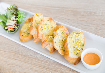 Garlic and herb bread on wooden table