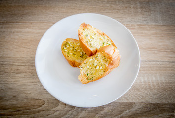 Garlic and herb bread on wooden table