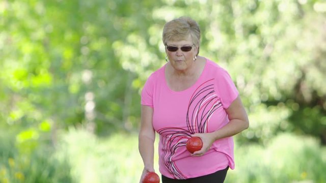 Elderly woman playing bocce ball