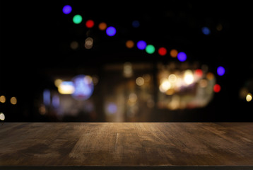 Empty of dark wooden table in front of abstract blurred background of bokeh light . can be used for display or montage your products.Mock up for display of product