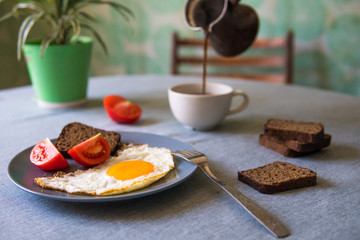 Breakfast fried egg and tomatoes.Coffee from cezve