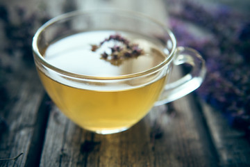 Green tea with herbals. Tea with oregano on the wooden background