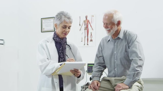 Doctor talking to elderly male patient