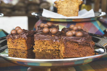 Cake Bars Topped with Chocolate Frosting and Milk Chocolate Balls