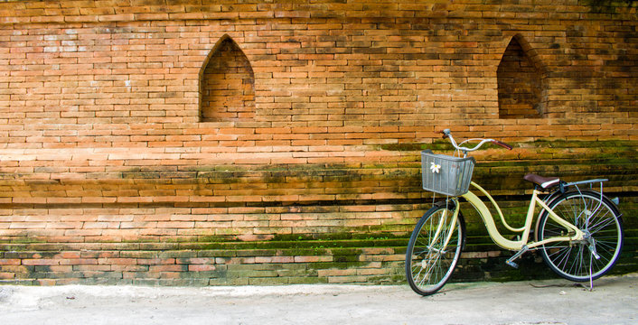Yellow bike And the walls made of brick Makes sense retro - Powered by Adobe