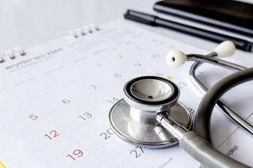 annual checkup concept. stethoscope on the calendar with soft-focus and over light in the background