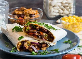 Wheat tortilla with a mixture of pork, beans, red onion and corn