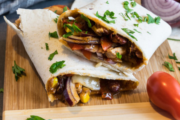 Wheat tortilla with a mixture of pork, beans, red onion and corn