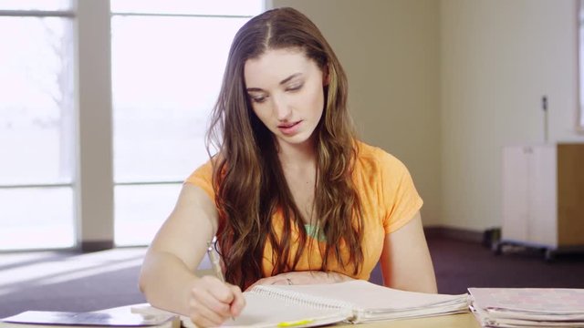 Portrait of woman using left hand to write and take notes