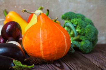 Rustic wooden table pumpkin eggplant broccoli pepper