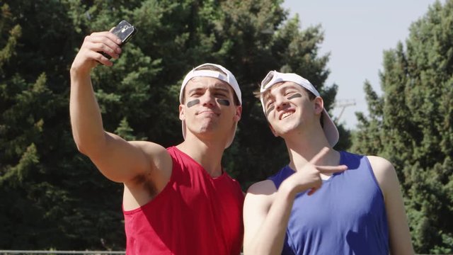Slow motion softball players taking a selfie