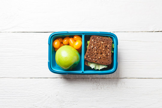 Photo of healthy food, apple, tomato, sandwich in box