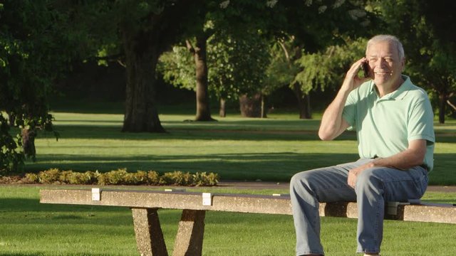 Elderly man with cellphone in the park