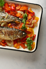Fish with vegetables on baking tray