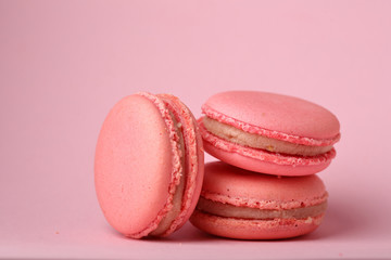 Pink cookies macarons on pink background