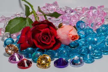 red rose and pink rose flowers are on the blue gemstones.