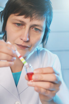 Female scientist in white coat working in laboratory