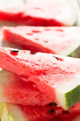 Ripe watermelon slices on a wooden table