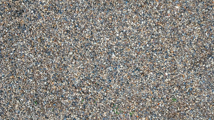 Stones on ground, background and texture form with a rocky surface on top. Gravel in the summer on site.