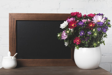 Flowers in vase and blank board