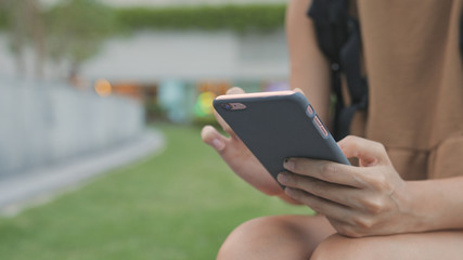 Woman use of smart phone in the city park