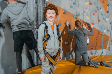 Fototapeta na wymiar boy in climbing harness at gym
