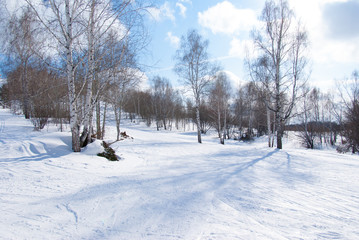 empty alpine ski slope in sunny early spring day