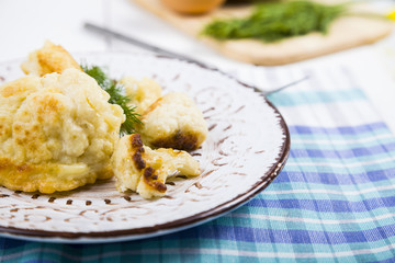 Fried cauliflower on a wooden table.