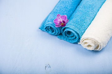 White and blue towels and an orchid flower.