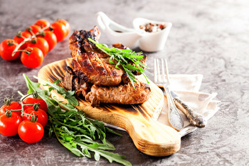 Grilled ribeye beef steak with tomatoes, herbs and spices. Selective focus