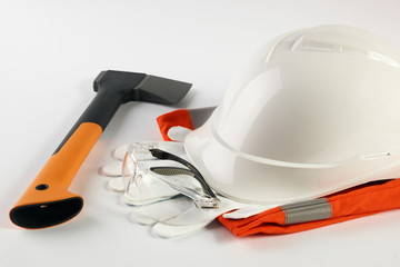 White hard hat with working tools isolated on a white