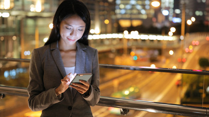 Business woman looking at mobile phone