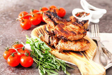 Grilled ribeye beef steak with tomatoes, herbs and spices. Selective focus
