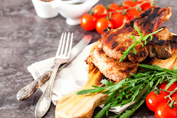 Grilled ribeye beef steak with tomatoes, herbs and spices. Selective focus