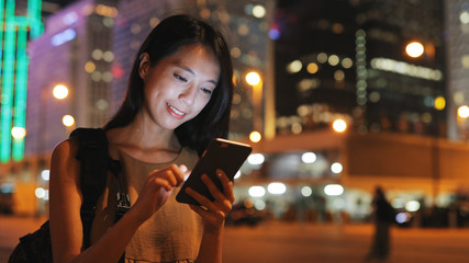 Woman use of smart phone in city