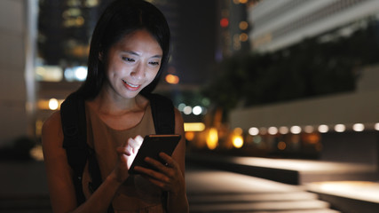 Woman use of smart phone in Hong Kong at night