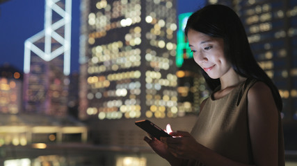 Woman text on cellphone at night