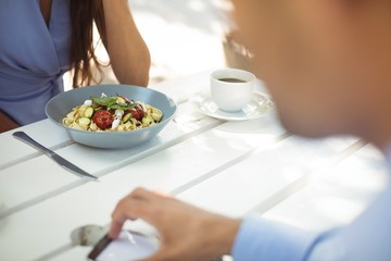 Obraz na płótnie Canvas Woman having vegetable salad at restaurant