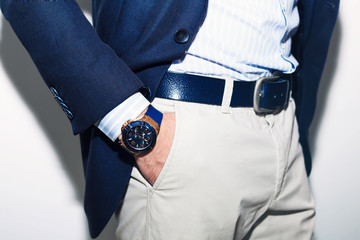 Closeup fashion image of luxury watch on wrist of man.body detail of a business man.Man's hand in a...