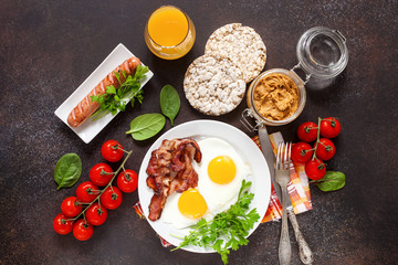 Flat lay of concept breakfast with setting food products over darken background. Top view